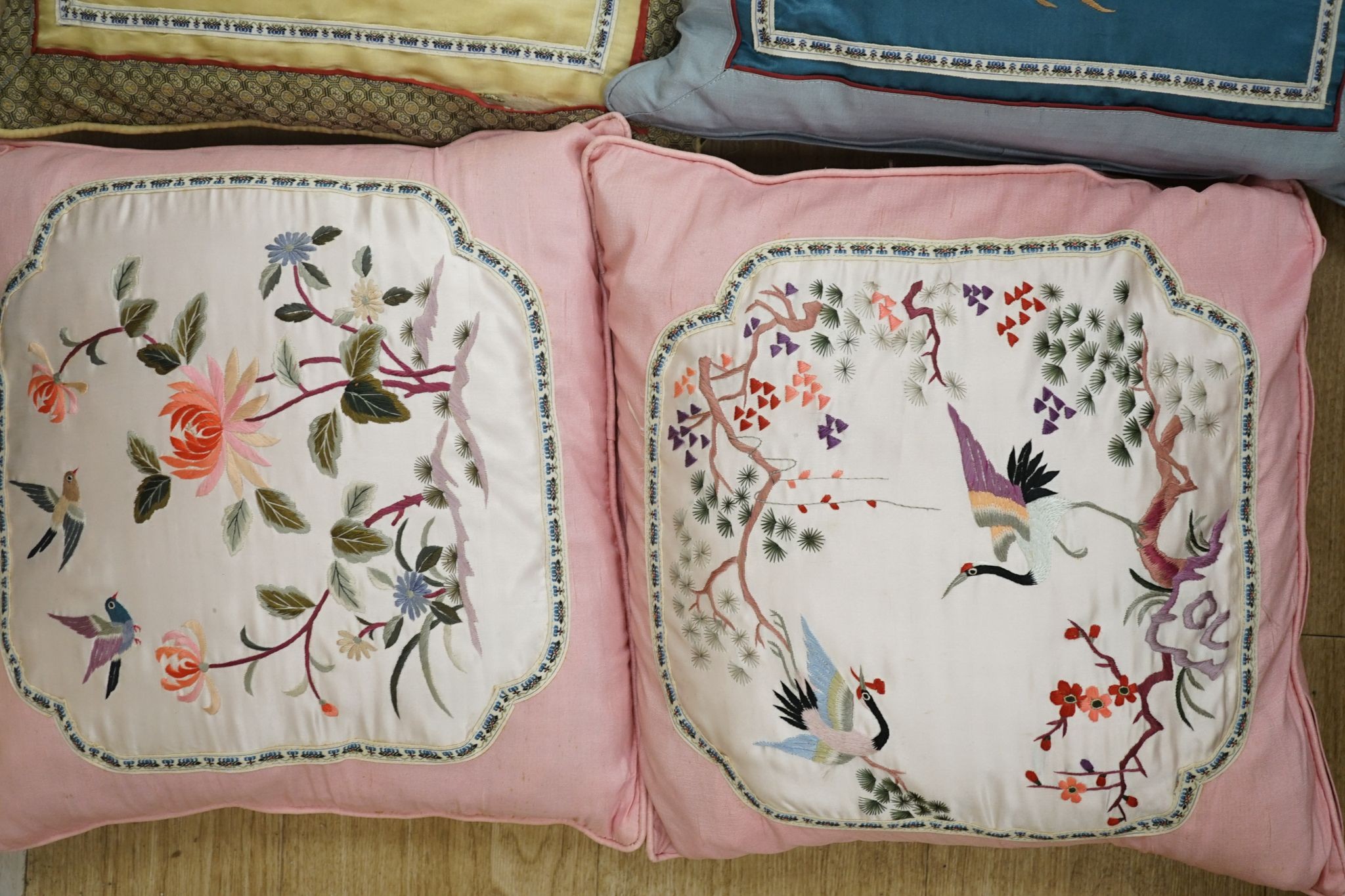 Three pairs of Chinese silk embroidered cushions and a cushion